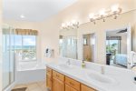 Master bathroom features a step in shower, jacuzzi tub, and double sink counter top.